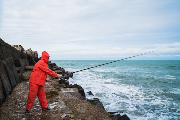 Old man fishing in the sea.