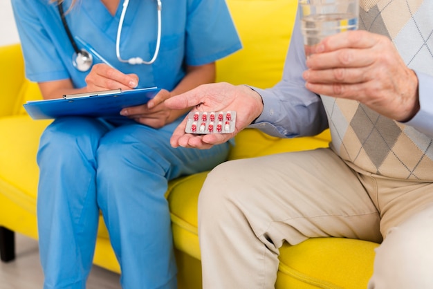 Free photo old man holding his pills