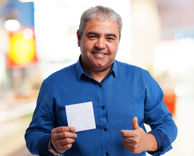 Old man holding a paper