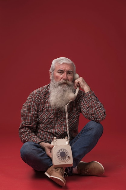 Old man holding a telephone