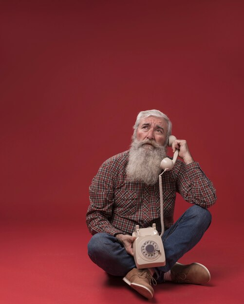 Old man holding a telephone