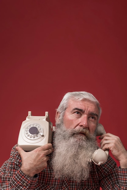 Old man holding a telephone