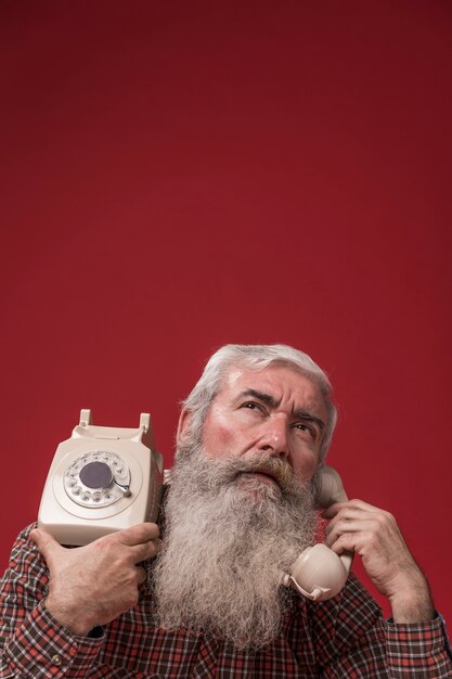 Old man holding a telephone