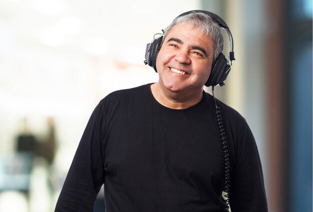 Old man listening to music with headphones