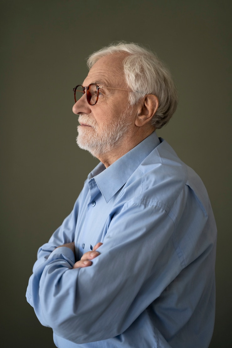 Free Photo old man posing indoors side view