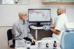 Free photo old man sitting in the dentist's office