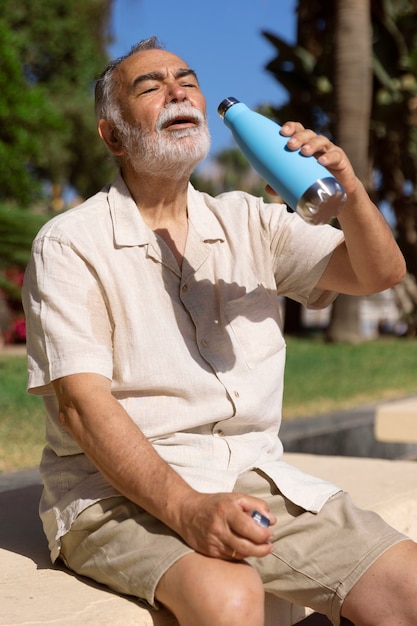 Old man struggling with high temperature