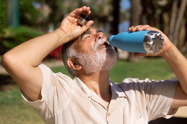 Free photo old man struggling with high temperature