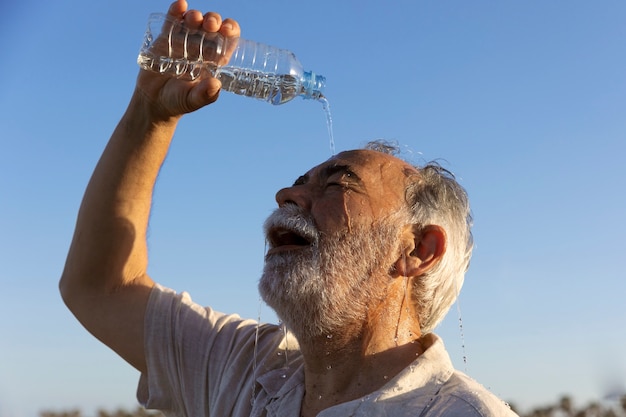 Old man struggling with high temperature