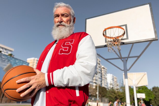 Free photo old man wearing varsity jacket outdoors