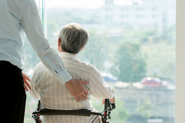 Old man on wheel chair and doctor in hospital healthcare and medical concept for comercial