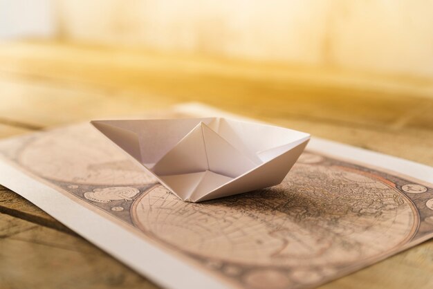Old map with paper boat