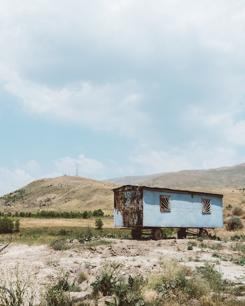 an old metal wagon on a mountain under a cloudy sky