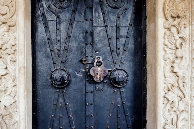 Old ornate church door with a lock