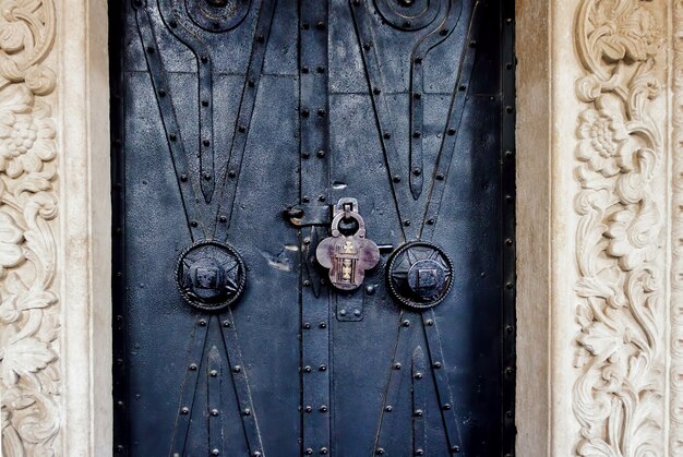 Old ornate church door with a lock