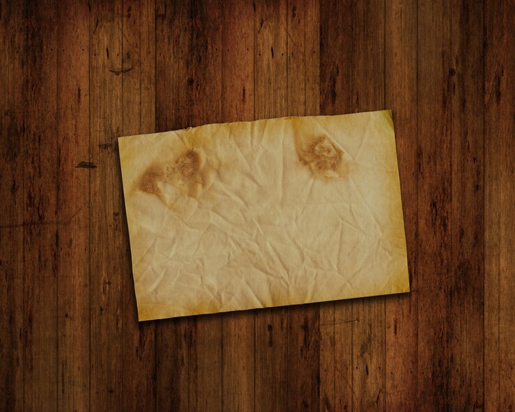 Free Photo old piece of paper on wood wall