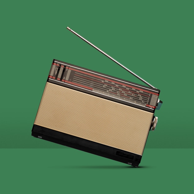 Free photo old radio balancing with green background