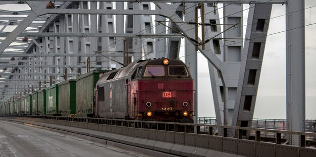 Old red train with green wagons during daytime