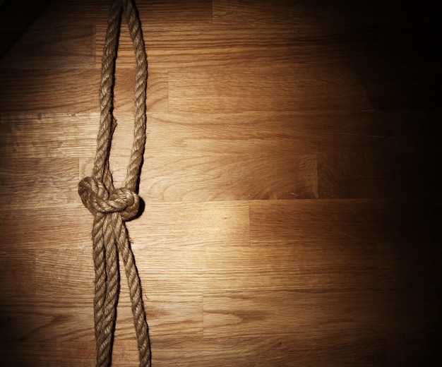 Free photo old rope over wooden surface