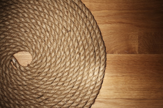 Old rope over wooden surface