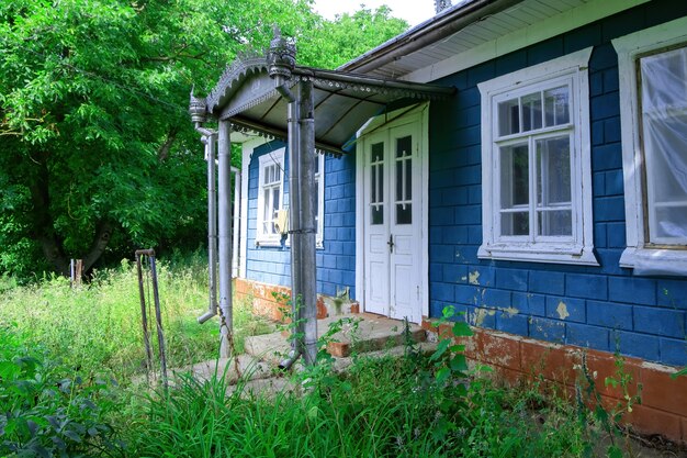 Old rural house with canopy over the entrance