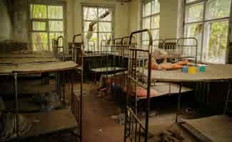 Free photo old rusty soviet beds in kindergarten at chernobyl ghost town ukraine