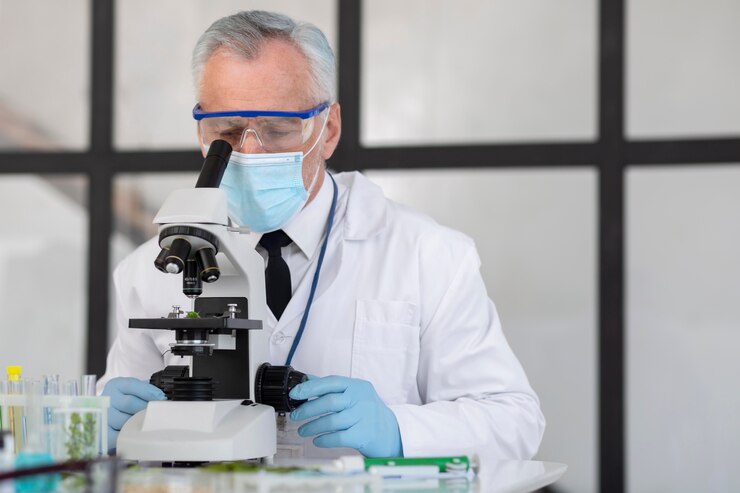 Free Photo old scientist working with microscope