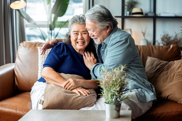 Old senior asian retired couple enjoy talking conversation together on sofa with happiness laugh smile and joyful at homeasian old mature adult stay home quarantine period concept