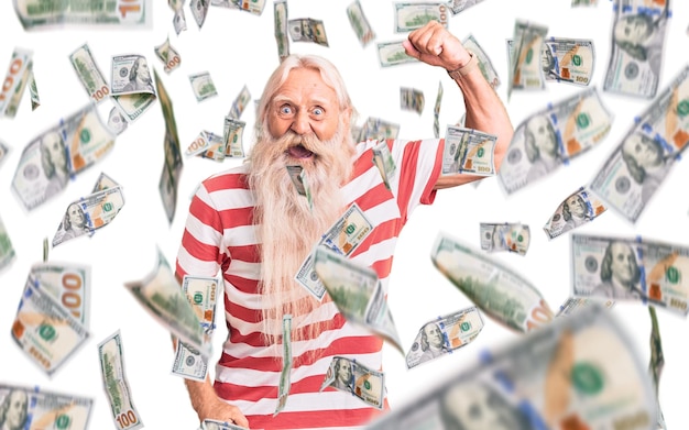 Free photo old senior man with grey hair and long beard wearing striped tshirt angry and mad raising fist frustrated and furious while shouting with anger rage and aggressive concept