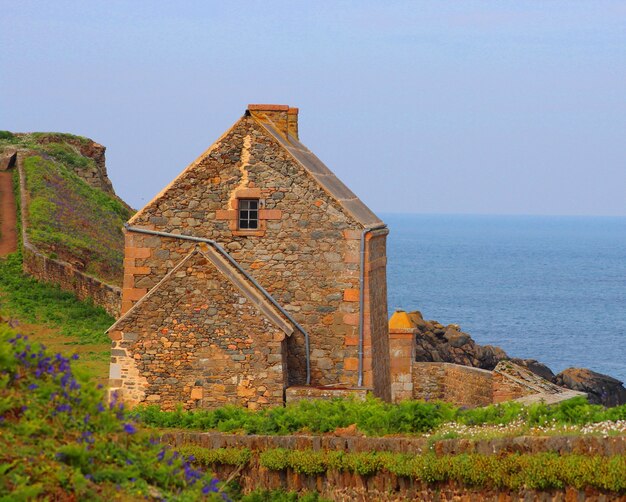 old stone house on a seascape background