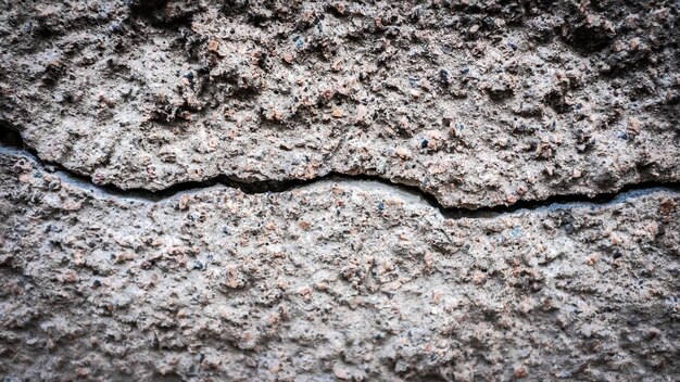Old stone wall with a crack. texture for design