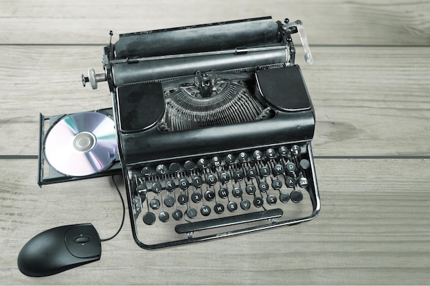 Old typewriter with cd  on background