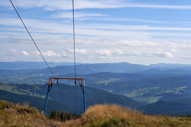 Old unused ski cable car in highland against cloudy blue sky