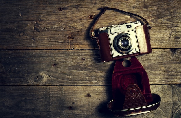 Old Vintage Camera on Dark Wooden Background. Horizontal with Copy Space.