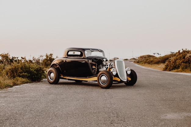 Free photo old vintage car parked in the middle of the freeway road