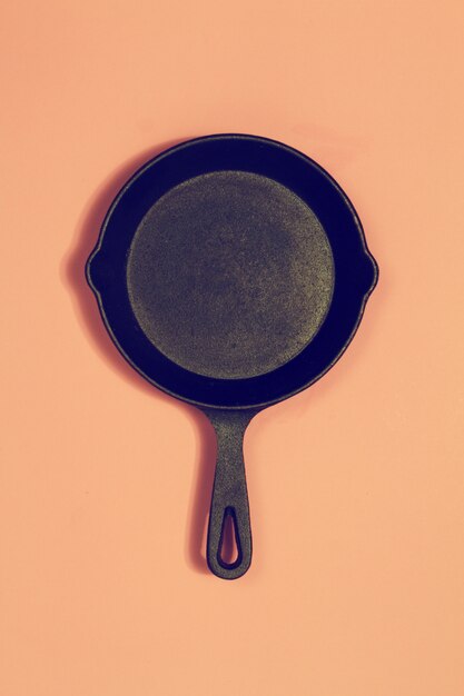 Old Vintage Pan on Pink Fashion Background. Toning. Top View. Cooking Concept.