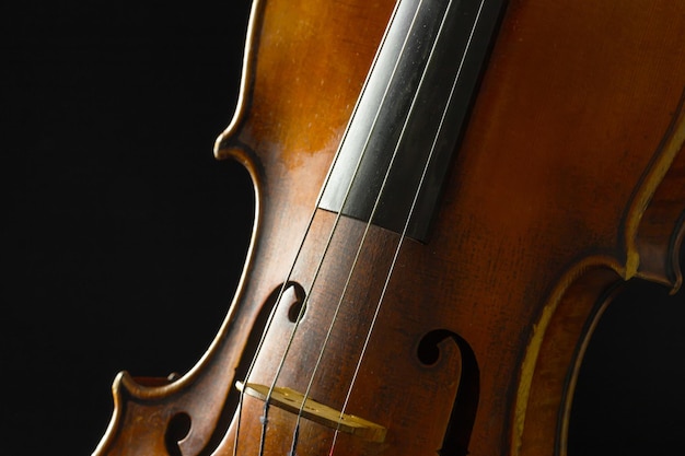 Old violin on a black background