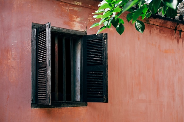 old window and pink wall in Hoi An, Vietnam