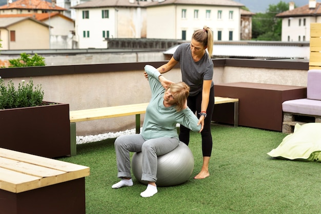 Old woman doing fitness exercises