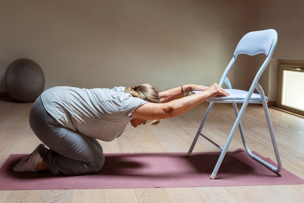 Old woman doing fitness exercises