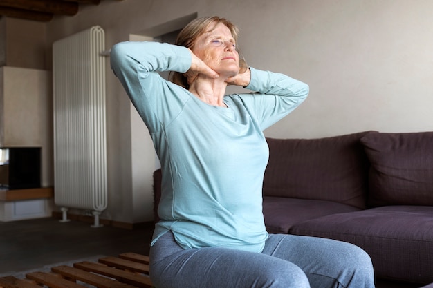 Old woman doing fitness exercises