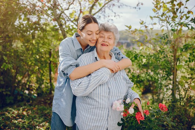 Old woman in a garden with young granddaughter