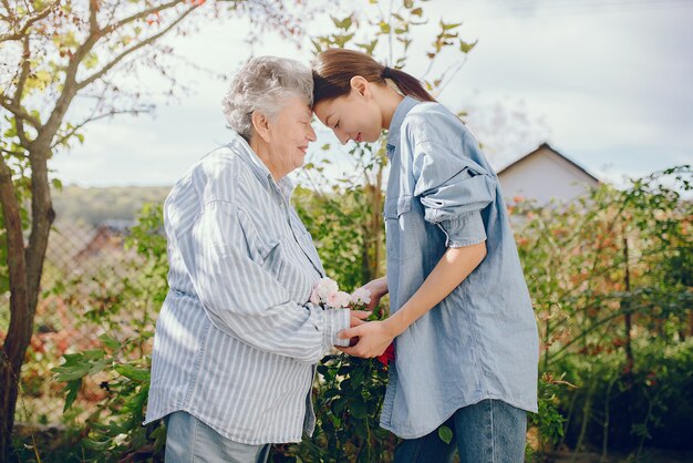 Old woman in a garden with young granddaughter