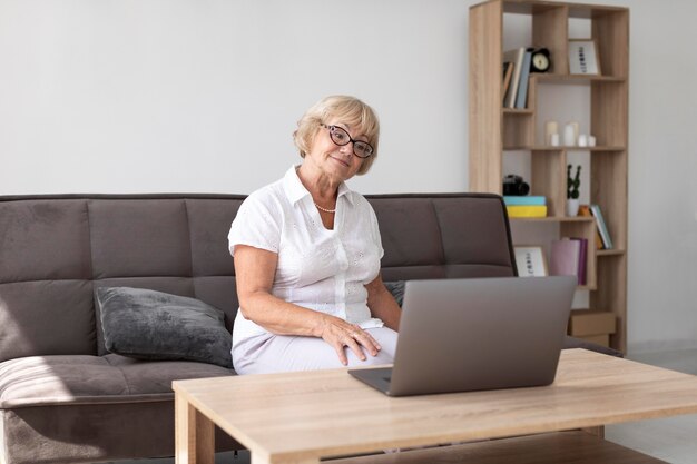 Old woman having a videocall with her family