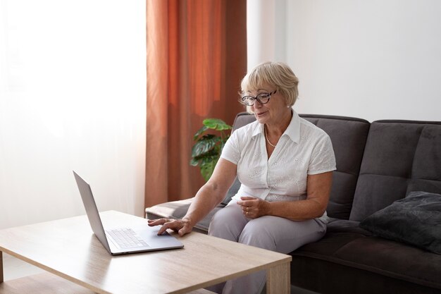 Old woman having a videocall with her family