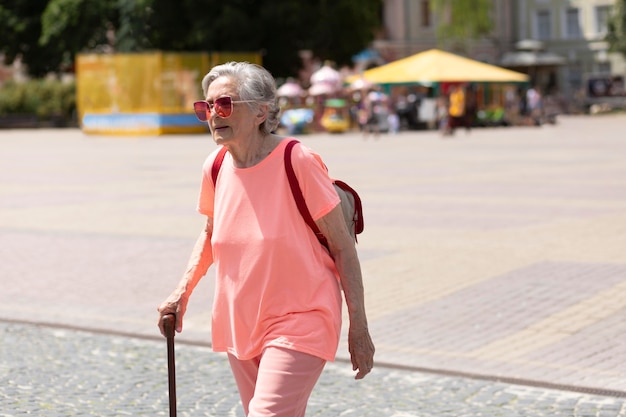 Free photo old woman traveling alone in the summer