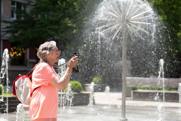 Free photo old woman traveling alone in the summer