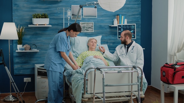 Old woman with sickness getting consultation from nurse and doctor