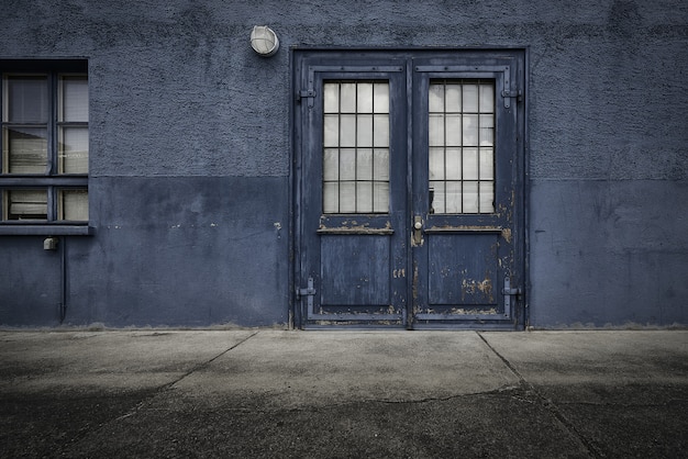 Old wooden door of a blue building during daytime