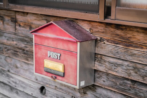 Old wooden mailbox on wood background